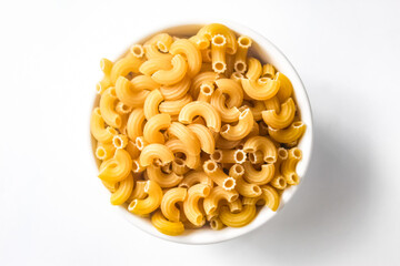 raw macaroni in a bowl isolated on white background