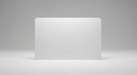 An elegant, simple white board stands against a smooth, softly lit gray backdrop, very clean.