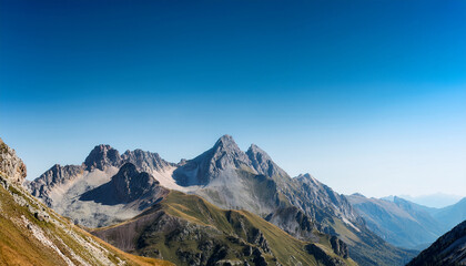 Fototapeta premium a mountain range with a clear blue sky in the background