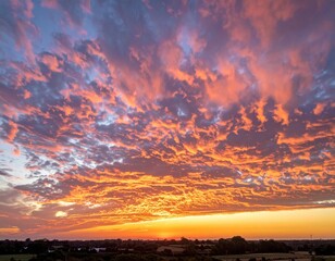 Fototapeta premium Stunning Sunset Overland with Dramatic Orange and Purple Cloud Formation