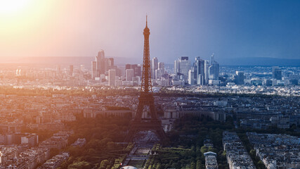 Warm sunset light illuminating the Eiffel Tower and Paris cityscape with La Defense business district in the background