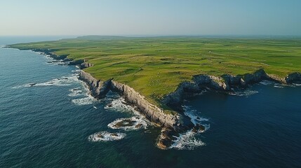 Coastal landscape of a grassy peninsula bathed in sunlight.