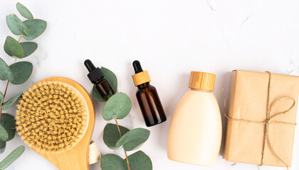 Naklejka premium Botanical Skincare Essentials: Natural skincare and self-care products artfully arranged with eucalyptus leaves, conveying a sense of well-being.