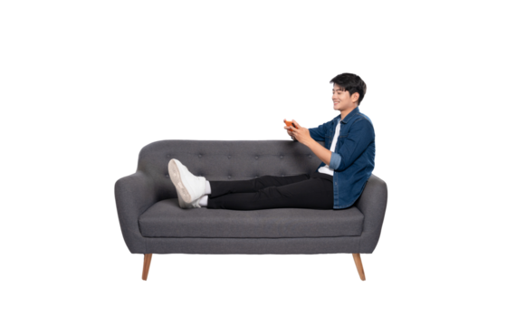 Full body image of young Asian man using phone sitting on sofa on PNG background	 - Powered by Adobe