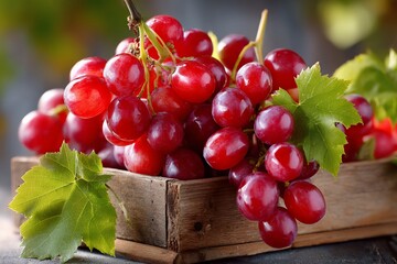 Red grapes cascade from a rustic wooden box