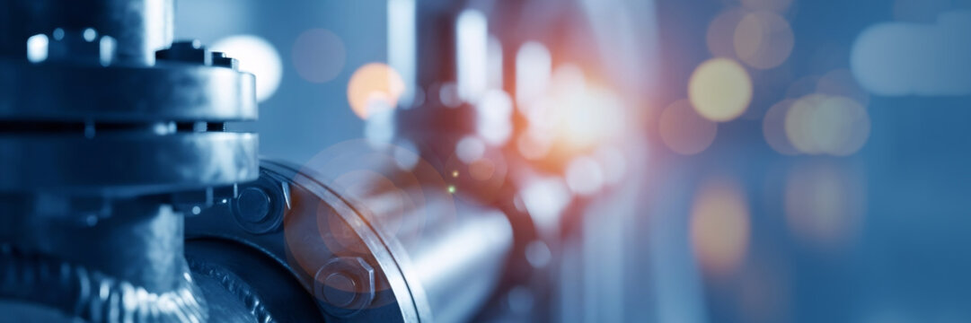 Close up of urban water system pipes. Industrial pipeline installation for city sewer. Blue tone image for water quality concept.