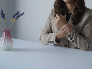 Businesswoman has severe wrist pain Wrist inflammation from sitting and working on a labtop Health care concept and office syndrome