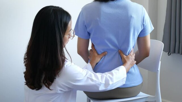 Asian female patient receives physical therapy with a spine physiotherapist, consultation and rehabilitation guidelines for the back, physical therapy, health from experts