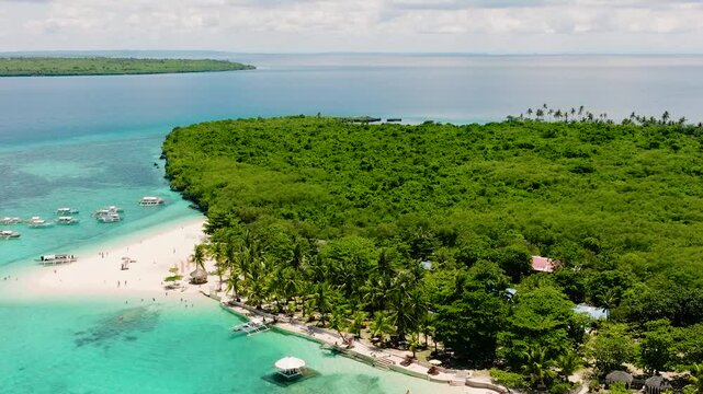 Seascape with tropical sandy beach and blue ocean. Virgin Island, Philippines.