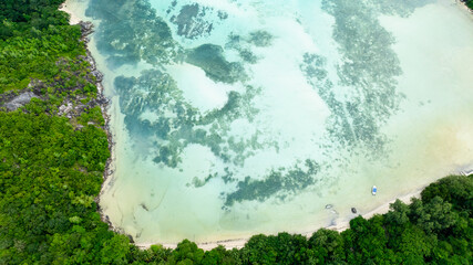 Mountainous terrain meets crystal clear ocean in stunning landscape. Seychelles, Mahe.