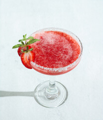 Top view refreshing strawberry Daiquiri Cocktail With Sugar Rim and Garnish on Bright Background