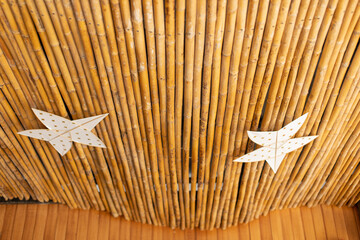 The bamboo ceiling is decorated with kites.