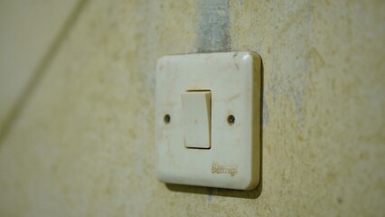 Vintage Light Switch on a Weathered Wall A Close-Up Photograph