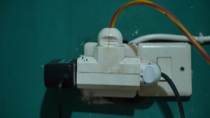 Close-up of a Worn-Out Electrical Outlet and Plugs