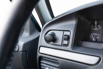 Close-up dashboard details of an older American pickup truck with 4x4 drivetrain. Features include control knobs, radio unit, climate panel, and gauges, all photographed in clean daylight conditions