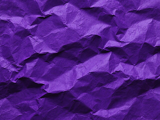 Textured close up view of crushed purple paper with abstract wri