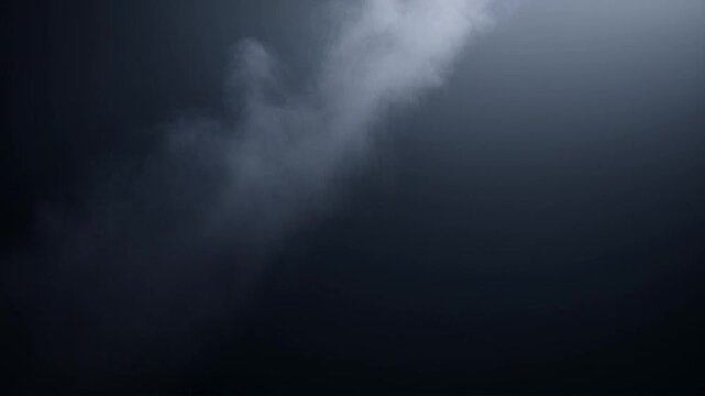 A dark, flat-colored background fills the frame, with a subtle layer of smoke or mist slowly rising and spreading out. The camera moves smoothly upward, creating a serene and ethereal atmosphere