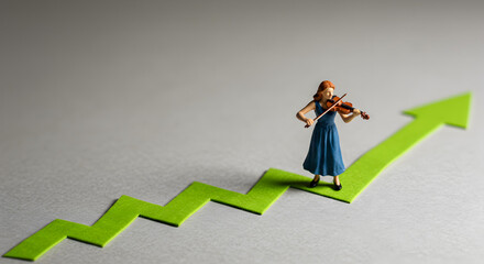 Miniature Woman in Blue Dress Playing Violin Atop Green Upward Arrow Against a Gray Background