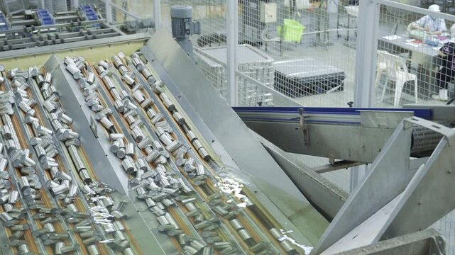 High angle view of canned goods submerged in water for sterilization in modern manufacturing