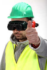 Worker with protective gear and thumbs up