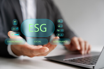 Businessman presenting ESG concept with icons of Environment, Social, and Governance, representing sustainable business, corporate responsibility, ethical investment, and green strategy.