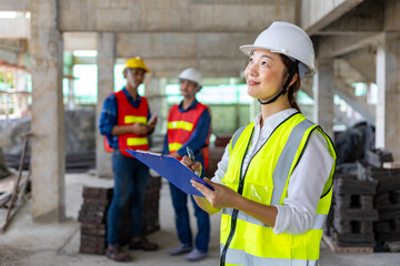 Team of asian engineer in full safety gear is inspecting inside the building structure for...
