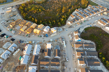Development of residential housing in the USA. Wooden frames of new cheap American homes under...