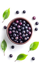 High-resolution image of acai berries in bowl with leaves, captured in a minimal flat lay or