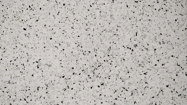 Mosaico de terrazo tonos negro y gris con base blanca. Se puede usar como fondo.
