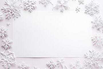 White snowflakes frame a blank paper on a pastel pink background