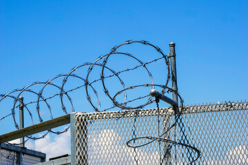 Barbed wire fence and security gate