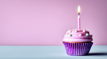 Single Pink Birthday Candle and Sweet Cupcake with Colorful Sprinkles 