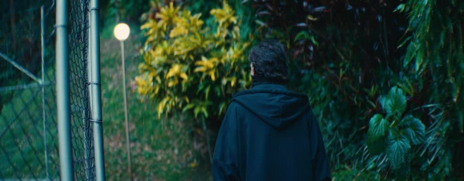 Walking behind a mysterious man wearing face mask