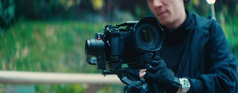 close up of a mirrorless camera being handled by a guy with a gimbal