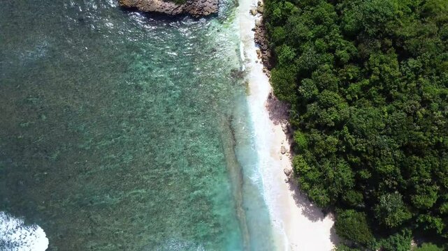 Aerial View of White Sand Beach and Iconic Watu Leter Islet &ndash; East Java, Indonesia