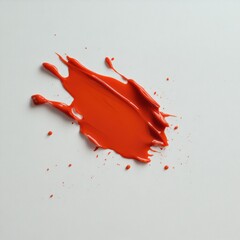 A vibrant splash of red paint on a clean white background, showcasing creativity.
