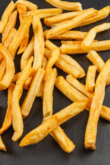 Freshly cooked fries on a dark surface ready to be enjoyed