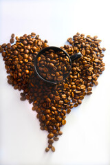 Black cup of coffee and heart made with coffee grains , affectionate. Freshly harvested coffee...