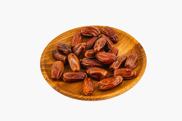 Delicious dried dates arranged on a wooden plate for serving