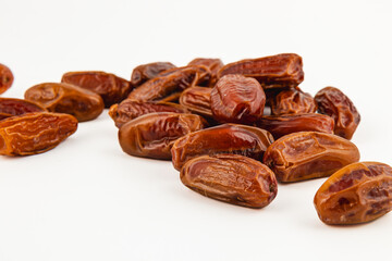Delicious fresh medjool dates arranged on a white surface