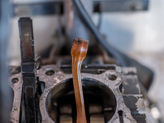 A damaged motorcycle connecting rod, showing signs of failure such as bending, cracks, or wear....