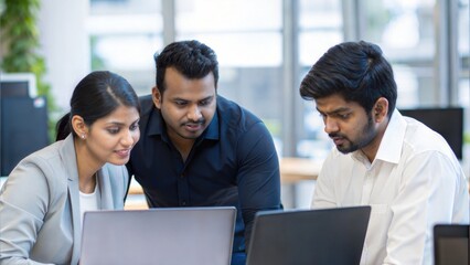 Indian Business Team Collaborating on Laptops in Modern Open Office
