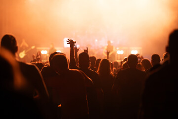 Crowd at concert and blurred stage lights.