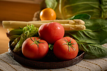 Fresh Tomatoes and Vibrant Vegetables in a Rustic Woven Basket