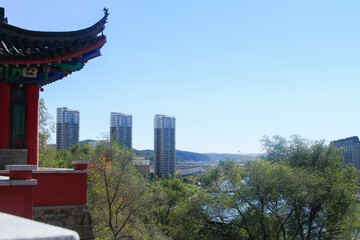 A Chinese tower temple architecture near a city.