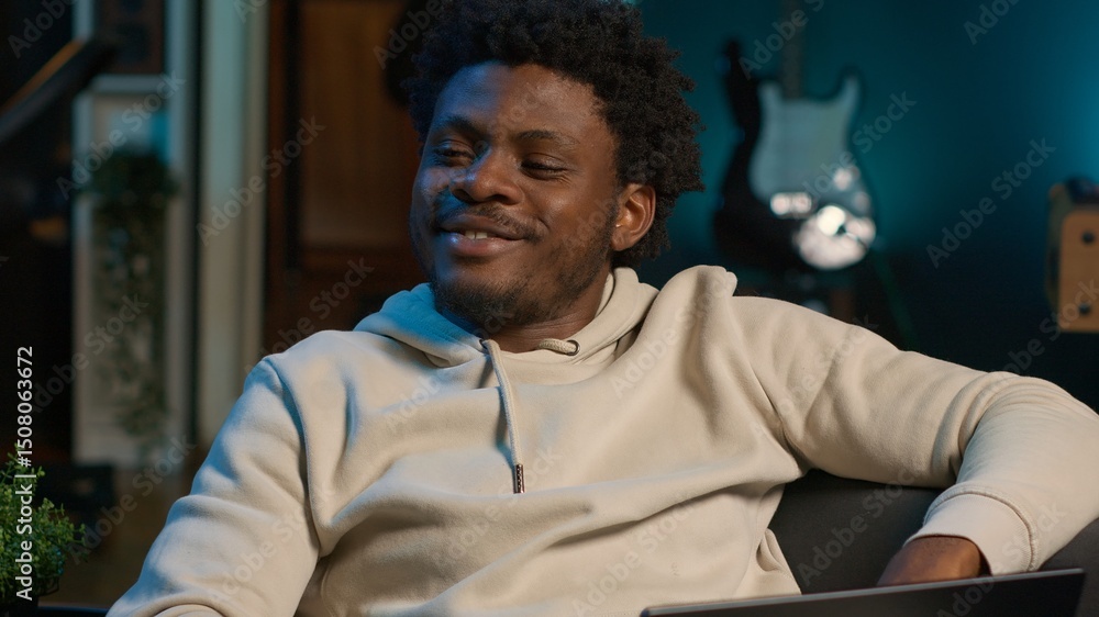 Poster black man does his research by reading articles and taking notes at home, collecting information for