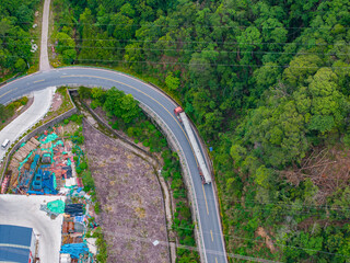 Large truck driving on green winding mountain road