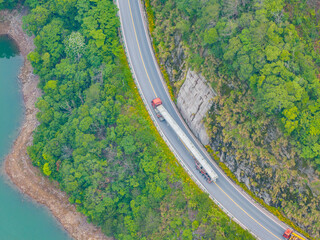 Large truck driving on green winding mountain road