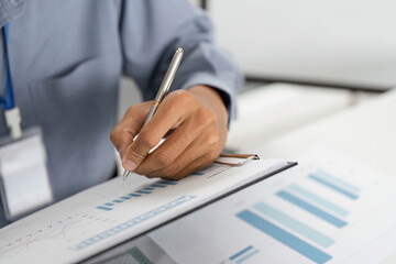 Naklejka premium Remote Work and Digital Transformation. Professional writing on document with graphs.