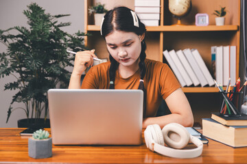 Homeschool Asian girl student learning virtual internet online class from school teacher by remote meeting. Female teaching math by headphone. education concept. student with computer study at school